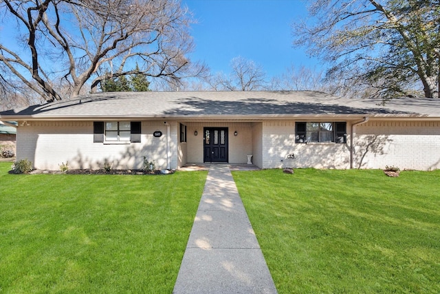 ranch-style house with brick siding and a front yard