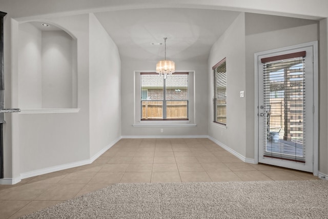 2217 Caroline Dr, Weatherford, TX 76087 - unfurnished dining area with an inviting chandelier, baseboards, and light tile patterned flooring