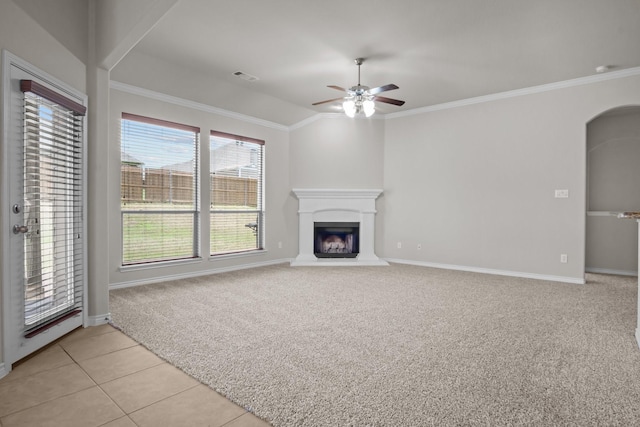 2217 Caroline Dr, Weatherford, TX 76087 - unfurnished living room with ceiling fan, visible vents, crown molding, baseboards, and a fireplace with raised hearth