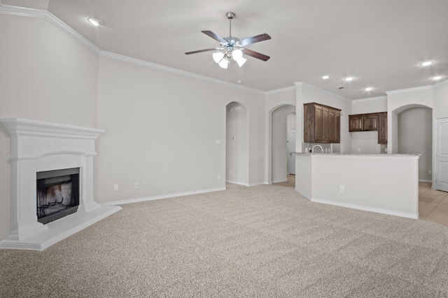 2217 Caroline Dr, Weatherford, TX 76087 - unfurnished living room with crown molding, a ceiling fan, recessed lighting, a fireplace with raised hearth, and arched walkways
