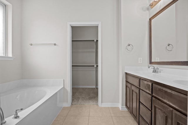 2217 Caroline Dr, Weatherford, TX 76087 - full bathroom with double vanity, a bath, a spacious closet, and tile patterned floors
