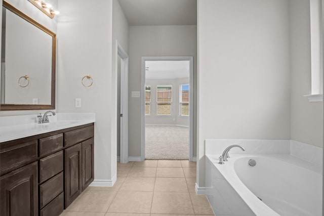 2217 Caroline Dr, Weatherford, TX 76087 - full bathroom featuring tile patterned floors, baseboards, a garden tub, and vanity