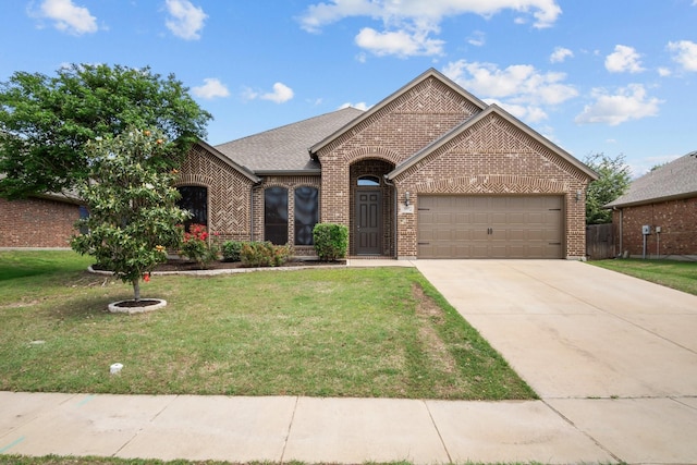 2217 Caroline Dr, Weatherford, TX 76087 - view of front of home with brick siding, a front lawn, an attached garage, and concrete driveway