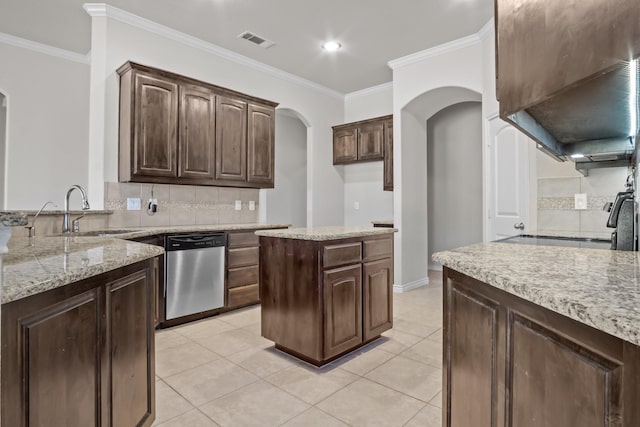 2217 Caroline Dr, Weatherford, TX 76087 - kitchen with a sink, arched walkways, tasteful backsplash, stainless steel dishwasher, and visible vents