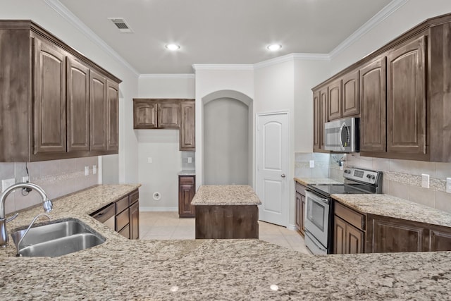 2217 Caroline Dr, Weatherford, TX 76087 - kitchen featuring visible vents, appliances with stainless steel finishes, tasteful backsplash, a sink, and ornamental molding