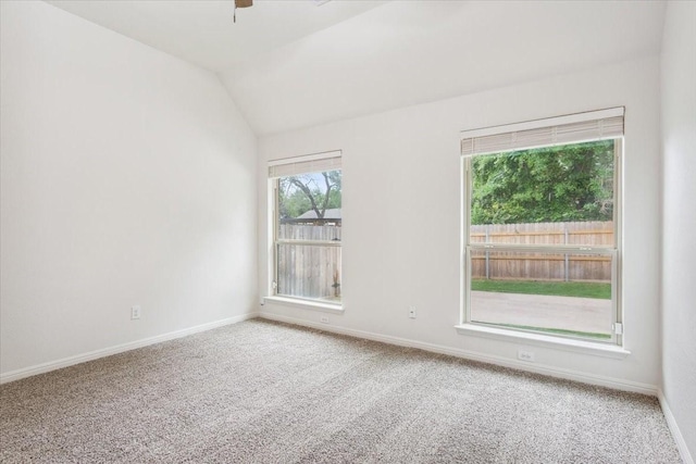 carpeted spare room with baseboards, ceiling fan, and lofted ceiling