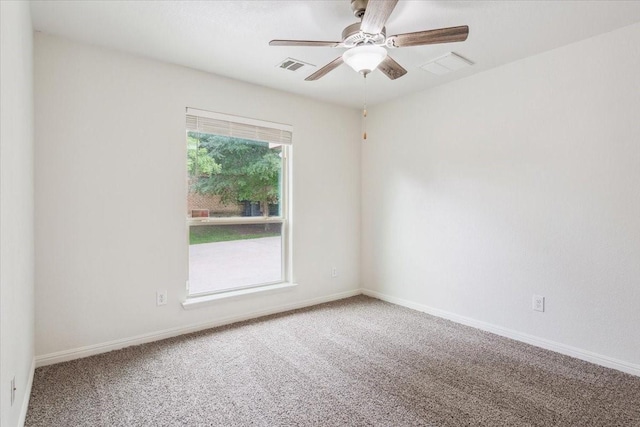 unfurnished room with carpet floors, a ceiling fan, and visible vents