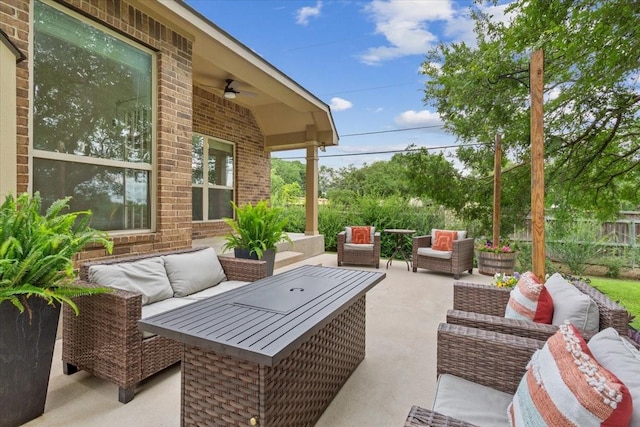 view of patio / terrace with an outdoor living space, a fenced backyard, and a ceiling fan