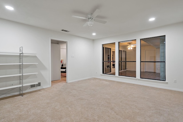 carpeted empty room featuring visible vents, a ceiling fan, and recessed lighting