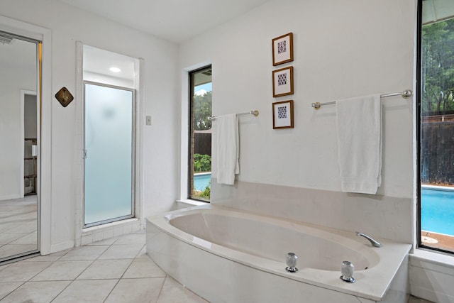 bathroom with a healthy amount of sunlight, tile patterned flooring, a garden tub, and a stall shower