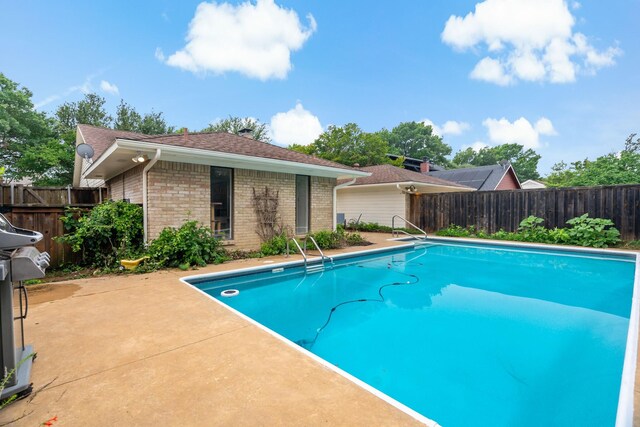 view of pool featuring a patio, a fenced in pool, and a fenced backyard