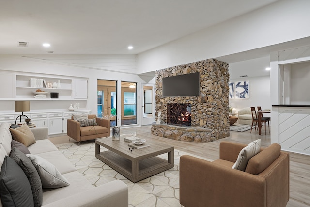 1308 Chesterton Dr, Richardson, TX 75080 - living room featuring a fireplace, light wood-style flooring, and lofted ceiling