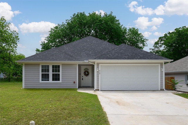 single story home featuring a garage, a shingled roof, a front yard, and concrete driveway