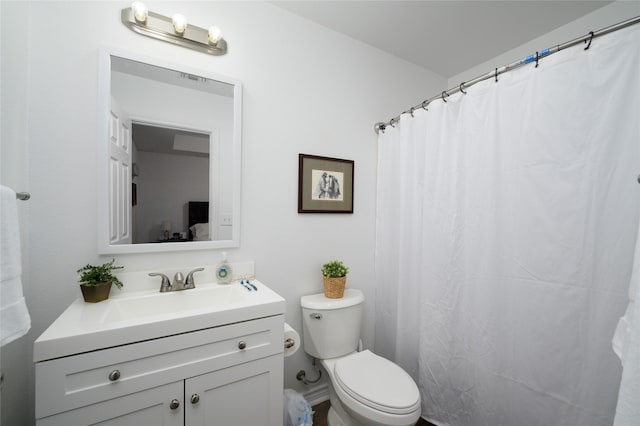 bathroom featuring vanity and toilet