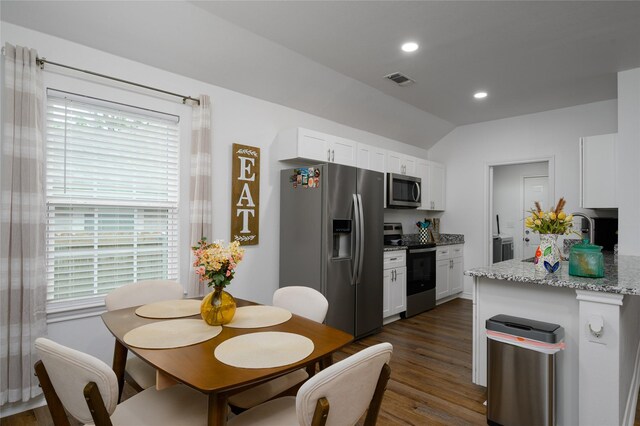 kitchen featuring appliances with stainless steel finishes, white cabinets, dark wood-style flooring, and visible vents