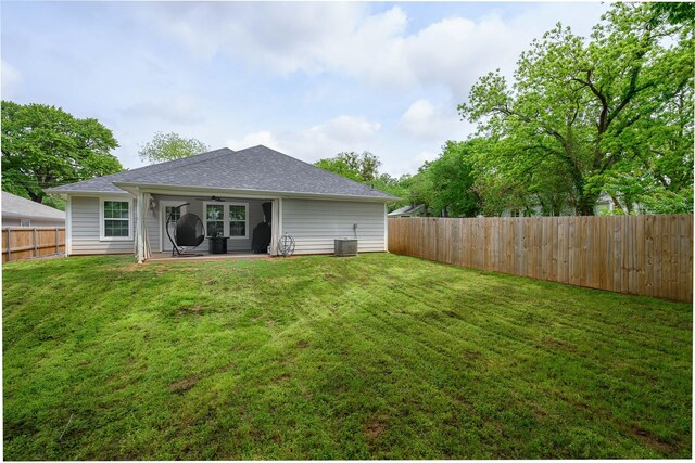back of house with a patio, a ceiling fan, a fenced backyard, and a yard