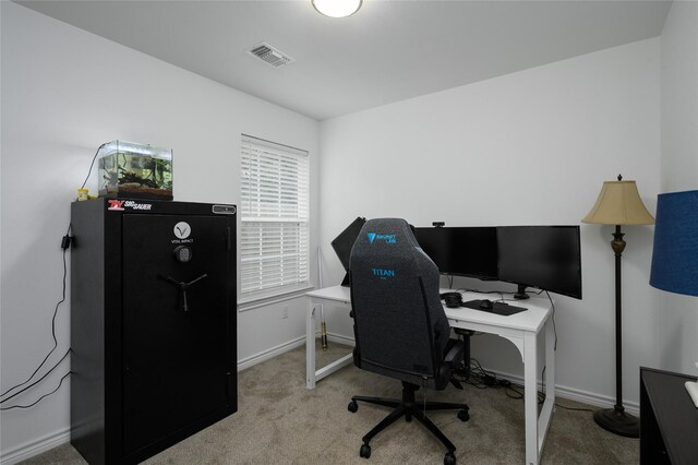 carpeted office space with baseboards and visible vents