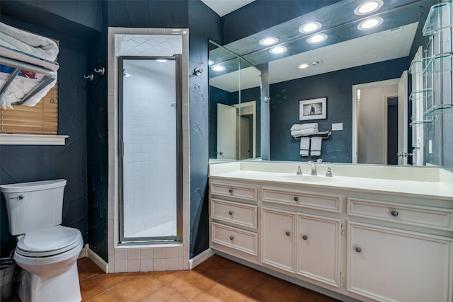 bathroom featuring vanity, tile patterned floors, toilet, and a shower stall