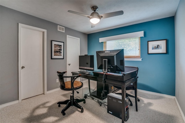office space with baseboards, ceiling fan, carpet, and visible vents