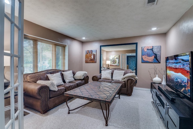 carpeted living room with recessed lighting, a textured ceiling, visible vents, and baseboards