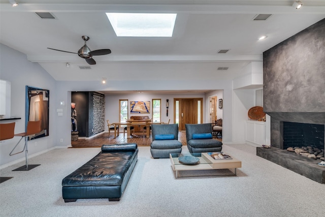 living area with baseboards, ceiling fan, a large fireplace, carpet, and vaulted ceiling