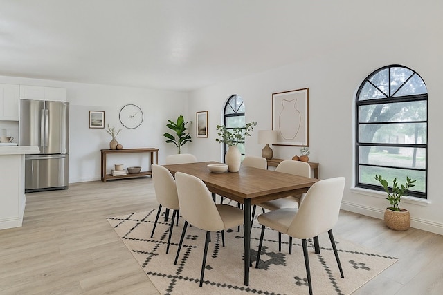 6401 Gate Ridge Cir, Garland, TX 75043 - dining space with light wood-style floors, baseboards, and a wealth of natural light