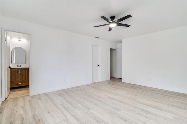 6401 Gate Ridge Cir, Garland, TX 75043 - unfurnished bedroom featuring visible vents, ensuite bathroom, baseboards, a sink, and light wood-style flooring