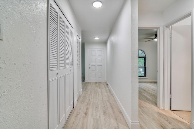6401 Gate Ridge Cir, Garland, TX 75043 - corridor featuring light wood finished floors and a textured wall