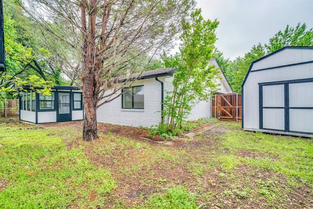 6401 Gate Ridge Cir, Garland, TX 75043 - view of yard featuring an outdoor structure, fence, a shed, a sunroom, and a gate