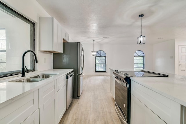 6401 Gate Ridge Cir, Garland, TX 75043 - kitchen featuring stainless steel dishwasher, electric range, light stone countertops, light wood-type flooring, and a sink
