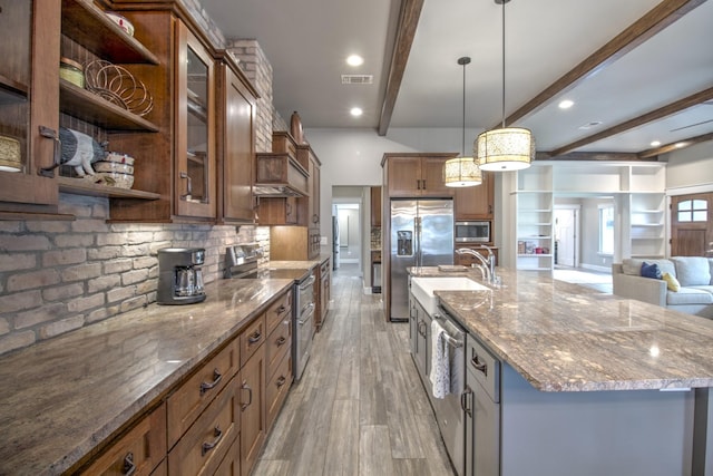 kitchen featuring appliances with stainless steel finishes, open shelves, beam ceiling, light wood-style flooring, and decorative backsplash