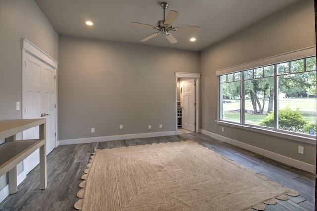 spare room with a ceiling fan, baseboards, dark wood-style floors, and recessed lighting