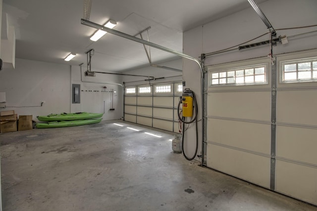 garage featuring electric panel and a garage door opener