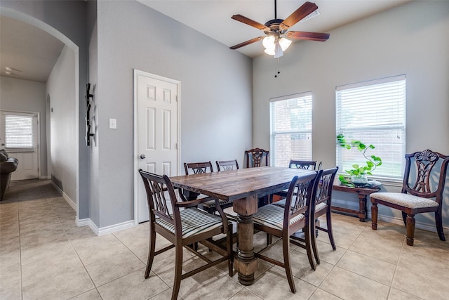 9204 Lockhart Dr, Arlington, TX 76002 - dining space with arched walkways, a ceiling fan, baseboards, and light tile patterned floors