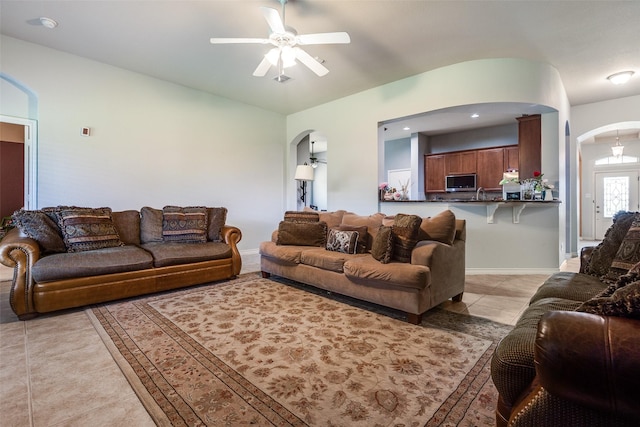 9204 Lockhart Dr, Arlington, TX 76002 - living area with arched walkways, a ceiling fan, light tile patterned floors, and lofted ceiling