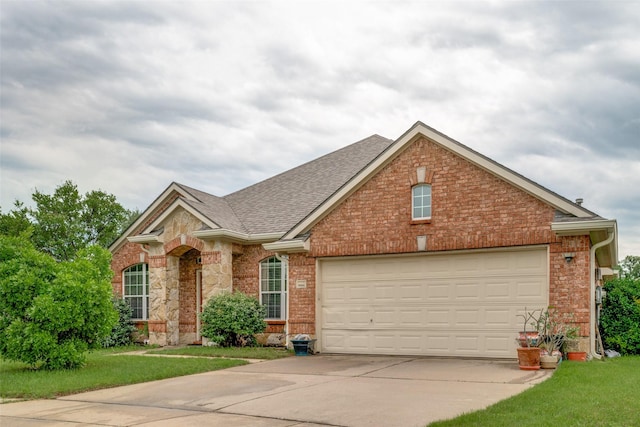 9204 Lockhart Dr, Arlington, TX 76002 - view of front facade with concrete driveway, roof with shingles, brick siding, and an attached garage