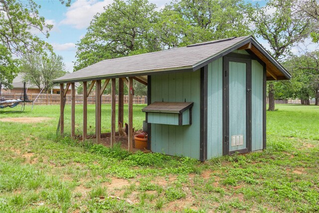 view of shed featuring fence