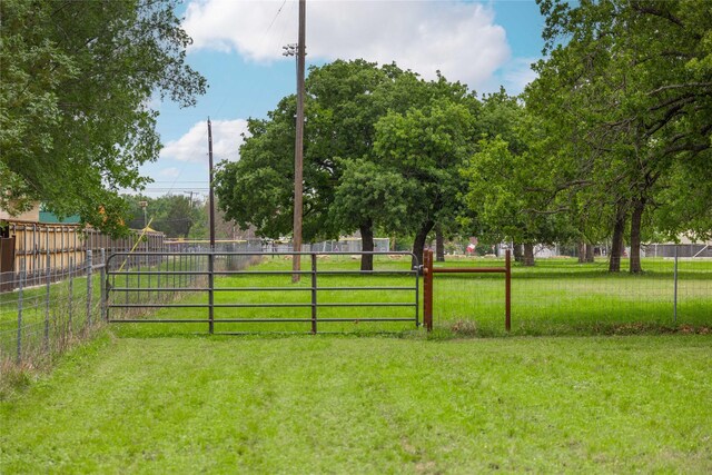 view of yard with fence and a gate