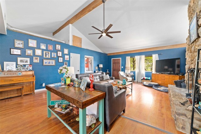 living room featuring high vaulted ceiling, beamed ceiling, a ceiling fan, and light wood finished floors