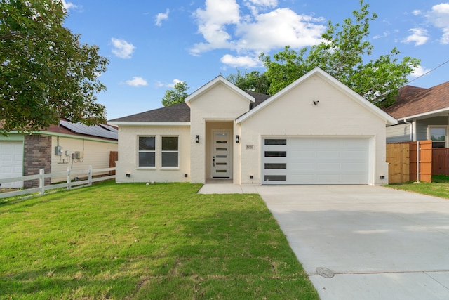 view of front of house featuring a front yard, fence, concrete driveway, an attached garage, and a shingled roof