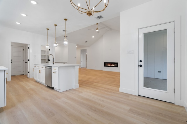 kitchen featuring visible vents, light countertops, white cabinets, lofted ceiling, and light wood-style flooring