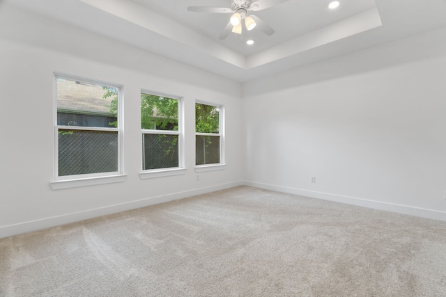 empty room with baseboards, recessed lighting, and light carpet