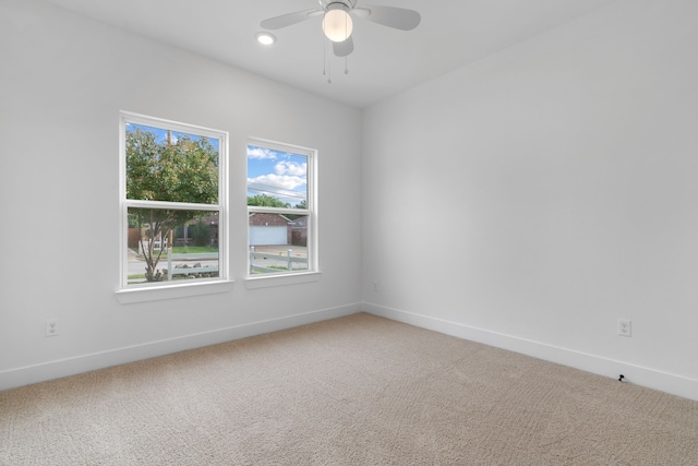 empty room featuring baseboards, ceiling fan, recessed lighting, and light colored carpet