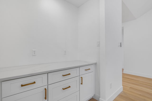 bathroom with baseboards and wood finished floors
