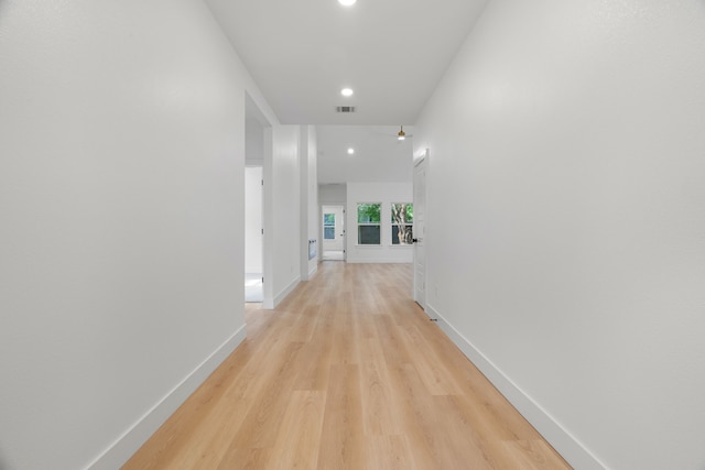 hall featuring recessed lighting, baseboards, visible vents, and light wood-style floors