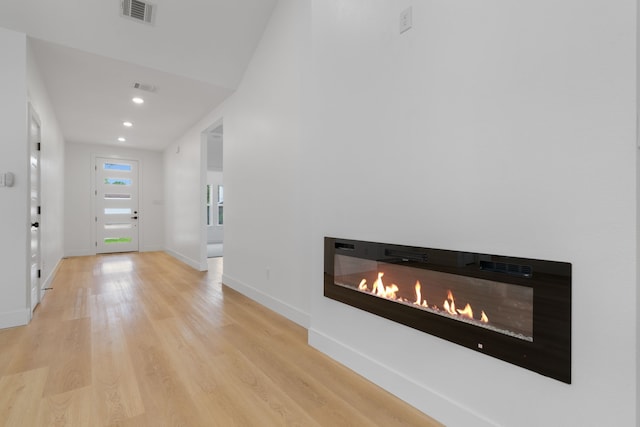 hall featuring recessed lighting, baseboards, visible vents, and wood finished floors