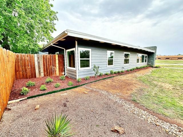 view of home's exterior with fence