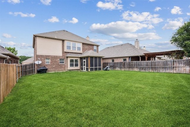 back of property featuring a sunroom, a fenced backyard, a lawn, and brick siding