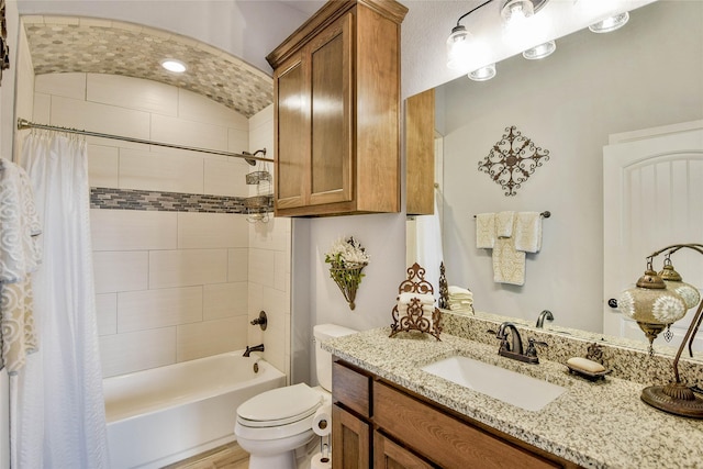 full bath with vanity, toilet, and shower / tub combo