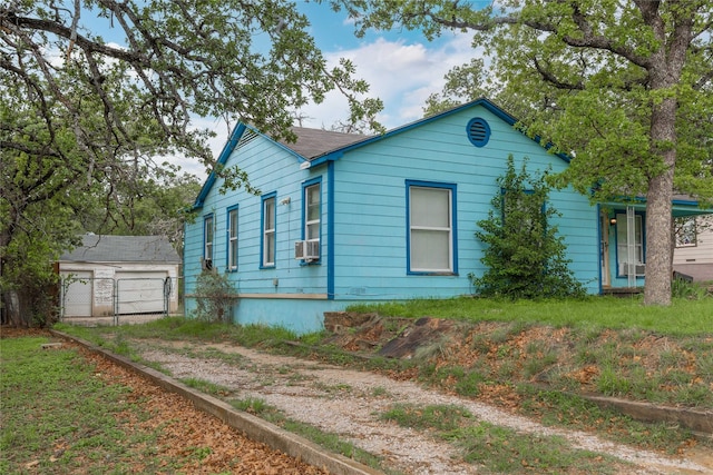 view of property exterior with fence, cooling unit, and a garage